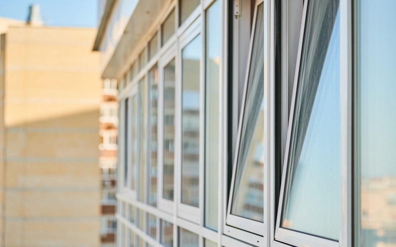 PVC windows on facade of skyscraper. Plastic double glazed windows. Building exterior.